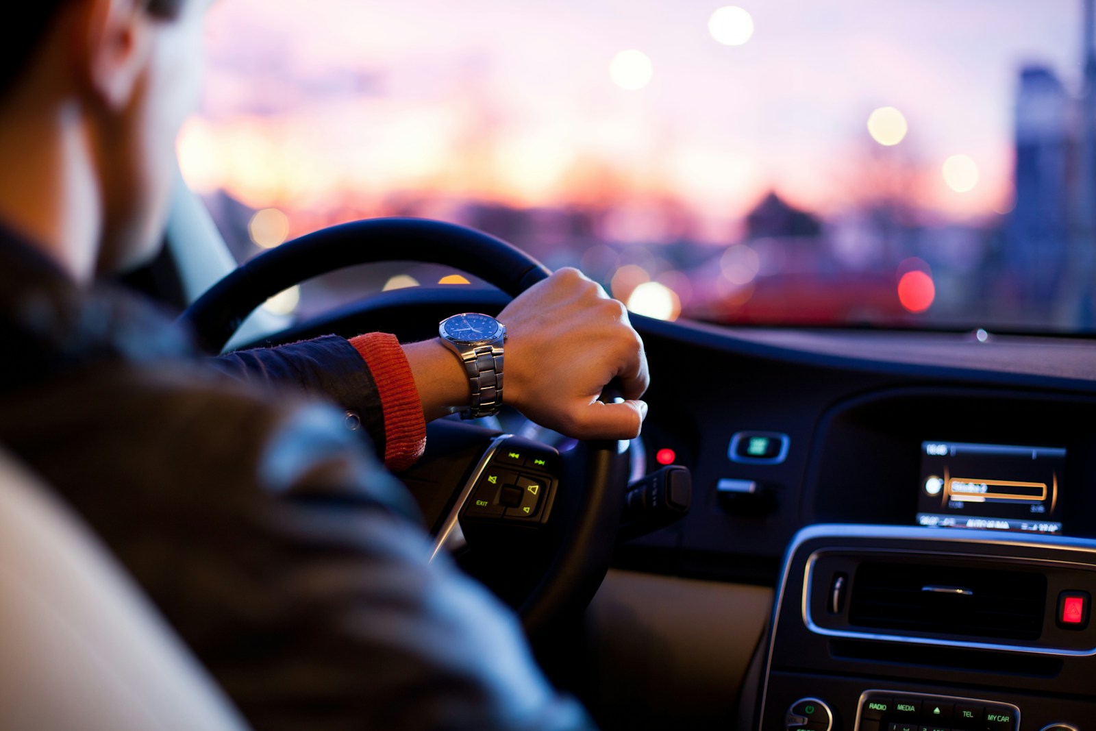 man driving a car wearing wrist watch sr-22 insurance